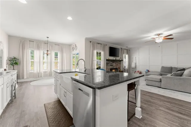 a kitchen with stainless steel appliances granite countertop a sink a stove and a refrigerator