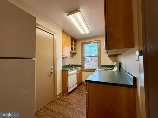 a kitchen with stainless steel appliances granite countertop a refrigerator a sink and a stove