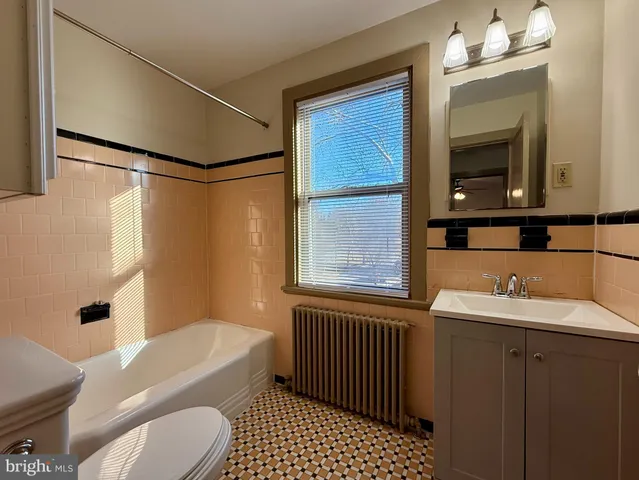 a bathroom with a sink a toilet and mirror