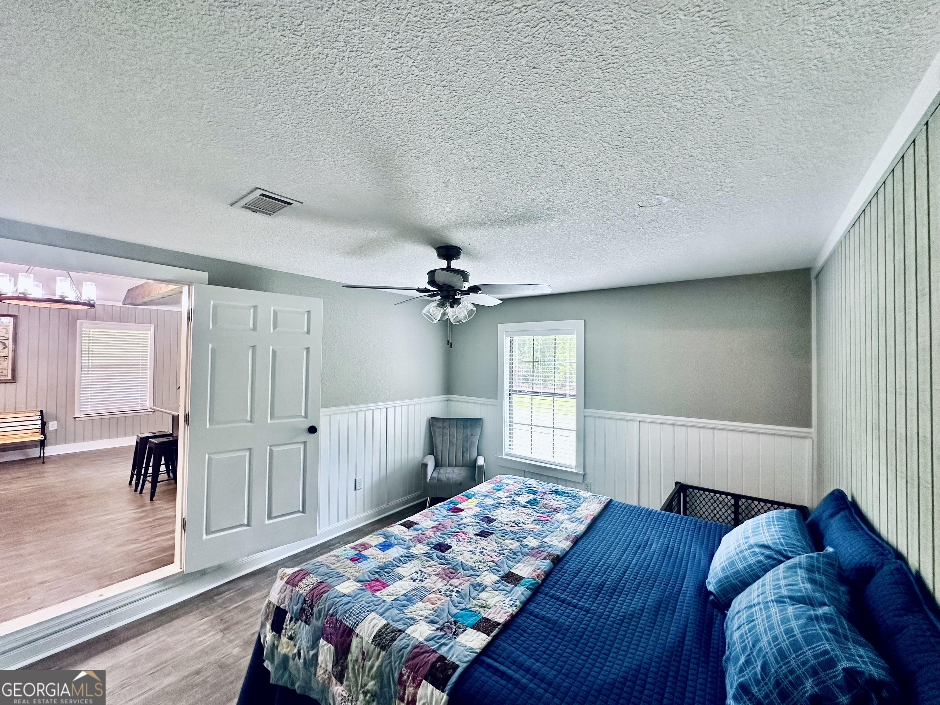 226 Cherokee Road Glenwood, GA 30428 - Photo 51 of 117 a bedroom with a bed and a chandelier