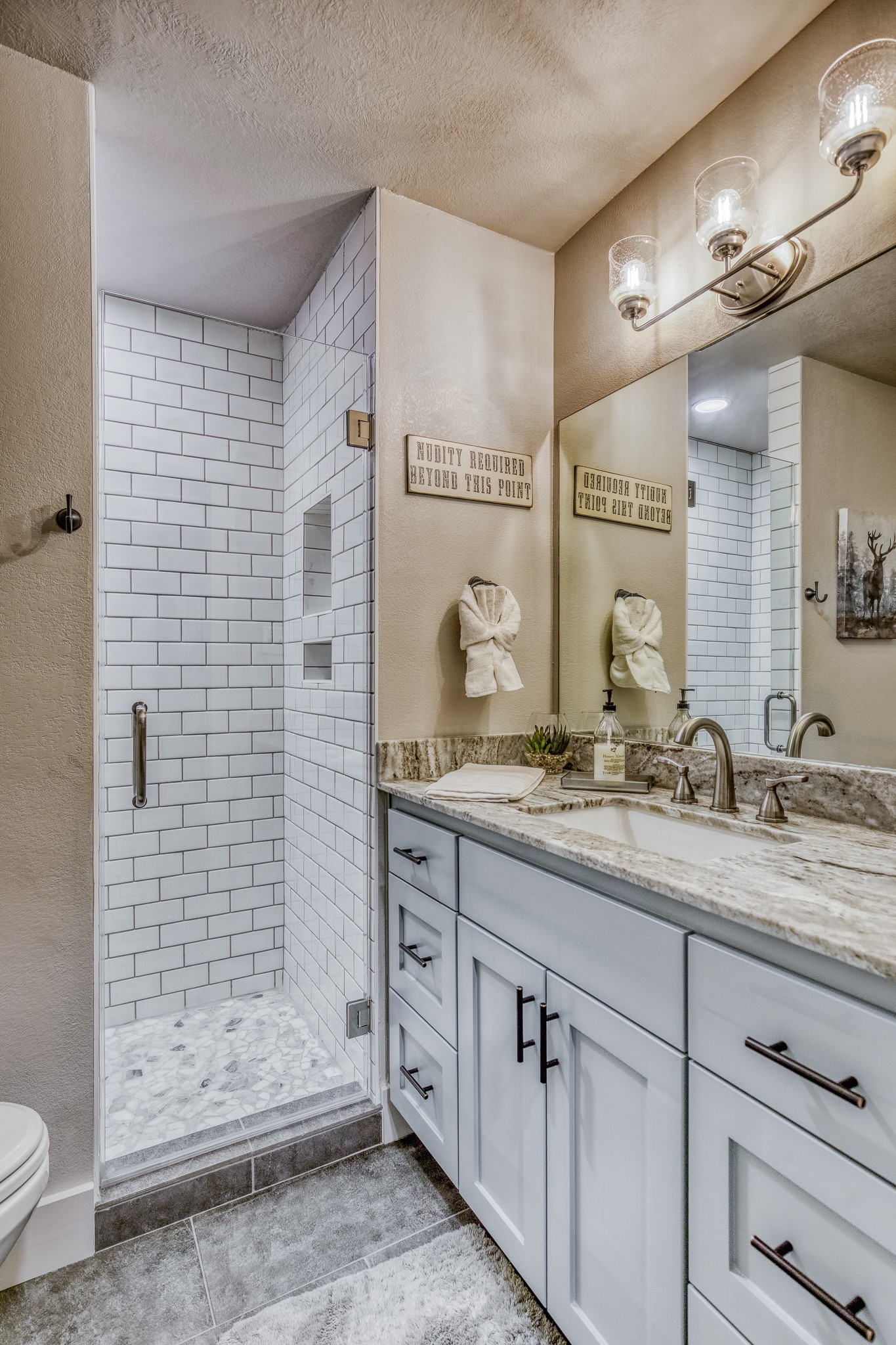5344 Andert Road Bryan, TX 77808 - Photo 14 of 50 a bathroom with a granite countertop sink a toilet a mirror and shower