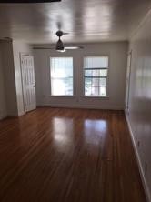 2104 Enfield Road Austin, TX 78703 - Photo 2 of 14 an empty room with wooden floor chandelier and windows