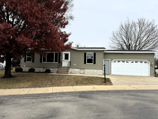a view of a house with a patio and a yard