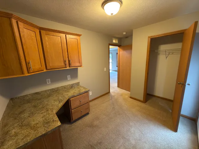 a kitchen with granite countertop a sink a stove and a refrigerator