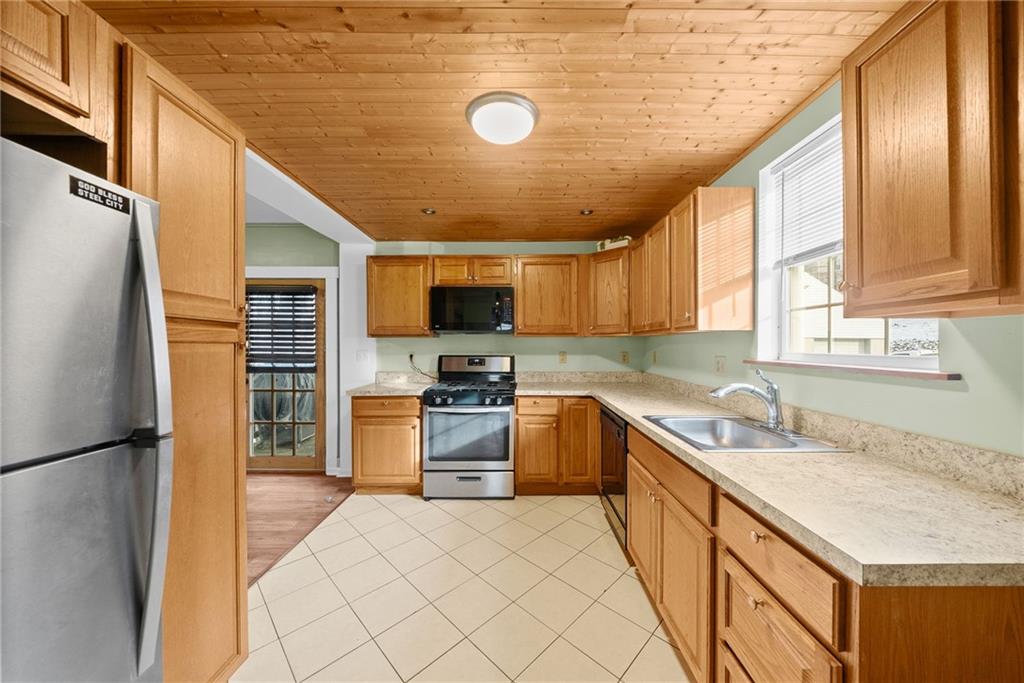 180 Hinkel Road Pittsburgh, PA 15229 - Photo 18 of 45 a kitchen with granite countertop a sink appliances cabinets and furniture