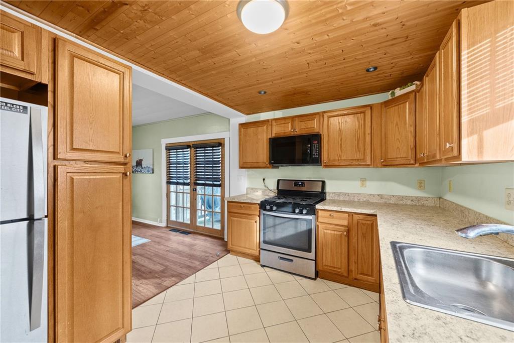 180 Hinkel Road Pittsburgh, PA 15229 - Photo 19 of 45 a kitchen with a sink a stove and refrigerator