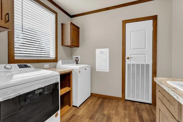a view of storage and utility room with wooden floor