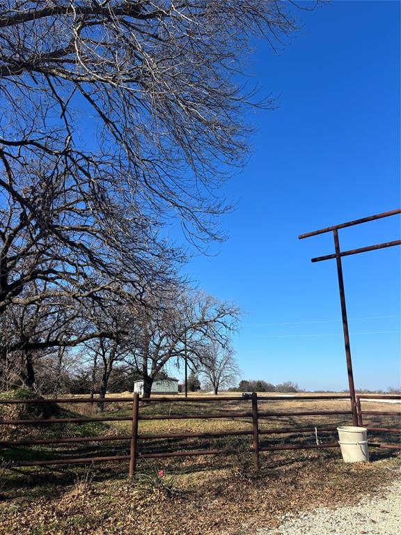 480 Cordell Road Sadler, TX 76264 - Photo 2 of 25 a view of a backyard with wooden fence