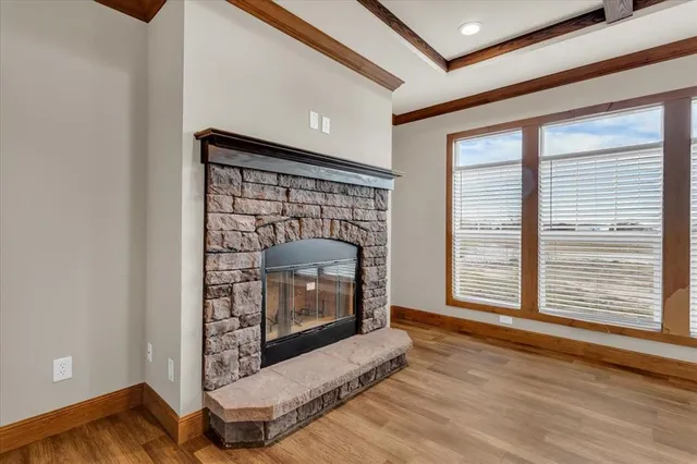 a living room with fireplace furniture and a wooden floor