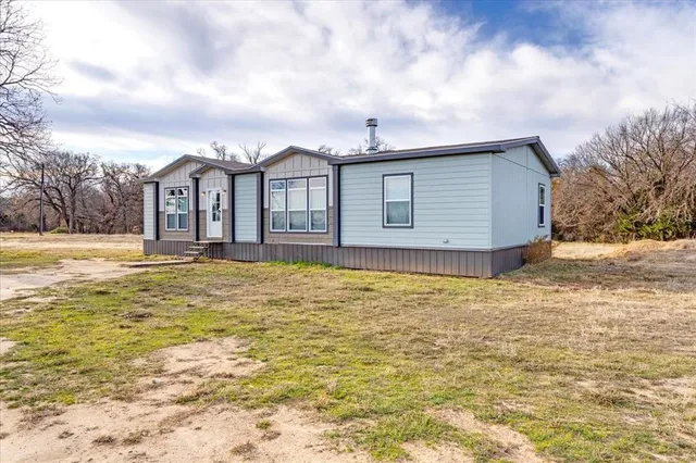 a large white house with a large pool of the house