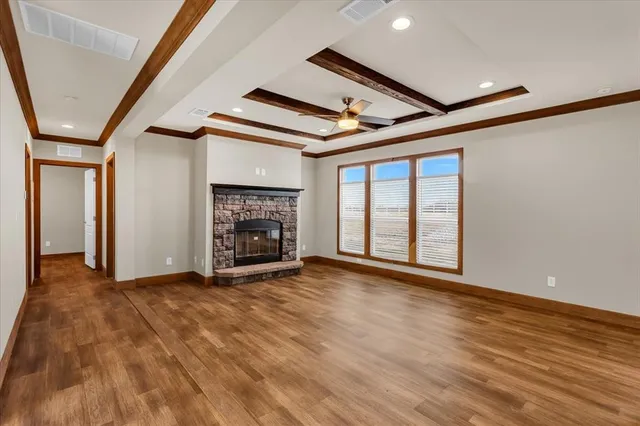 a view of an empty room with a fireplace and a window