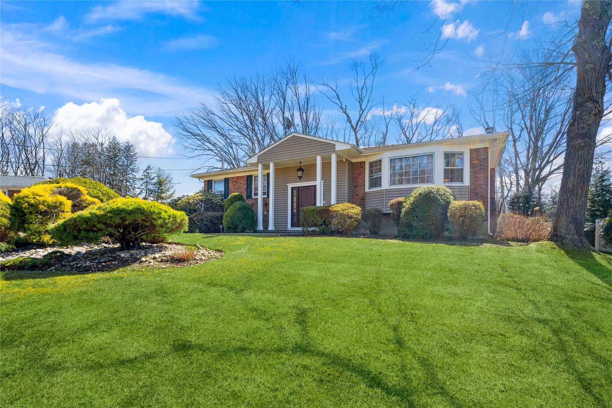 Single story home with a front yard and brick siding