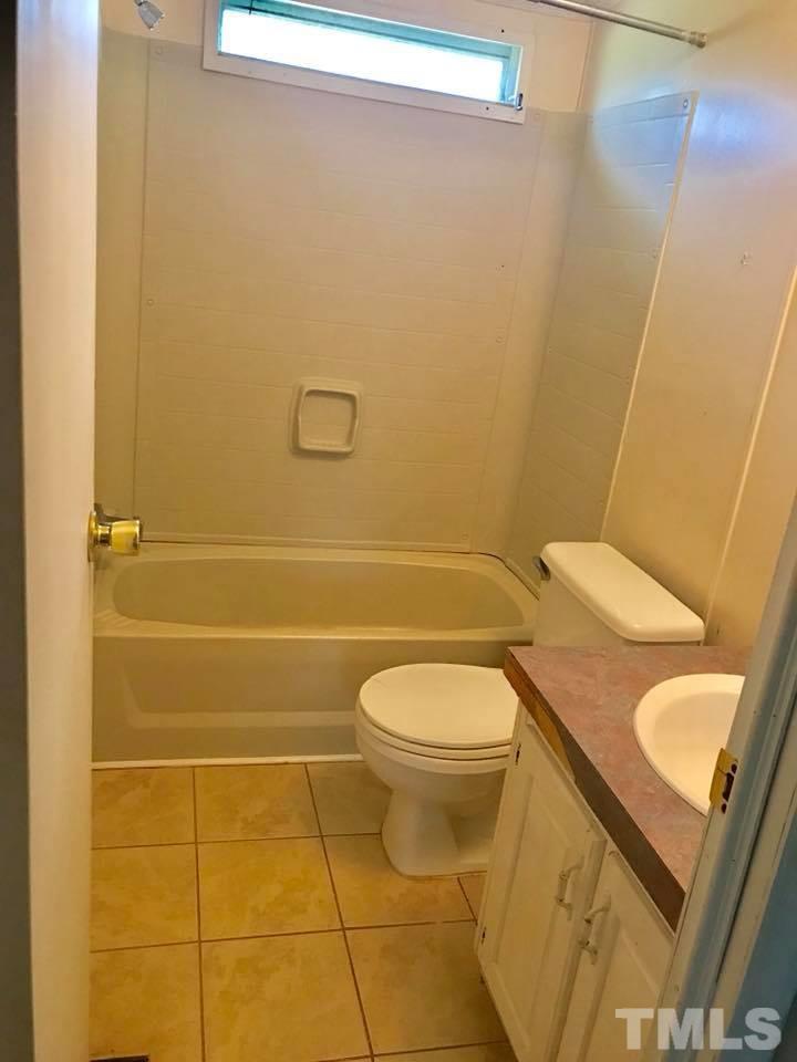 1840 Antioch Church Road Timberlake, NC 27583 - Photo 14 of 18 a bathroom with a sink and toilet