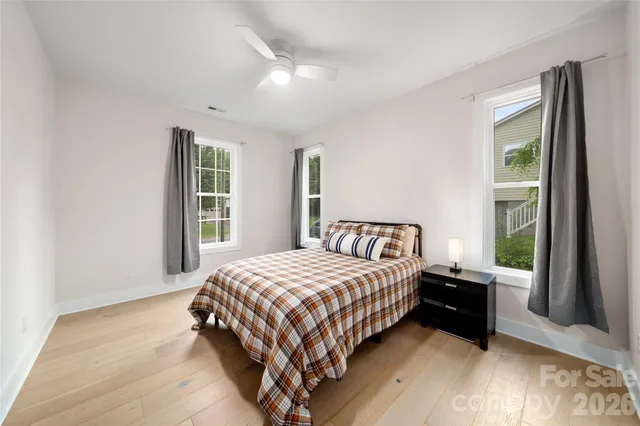 a bedroom with a bed and a large window