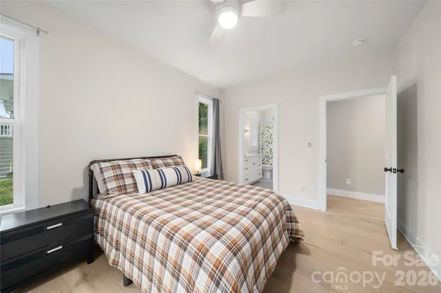 a bedroom with a bed and a night stand