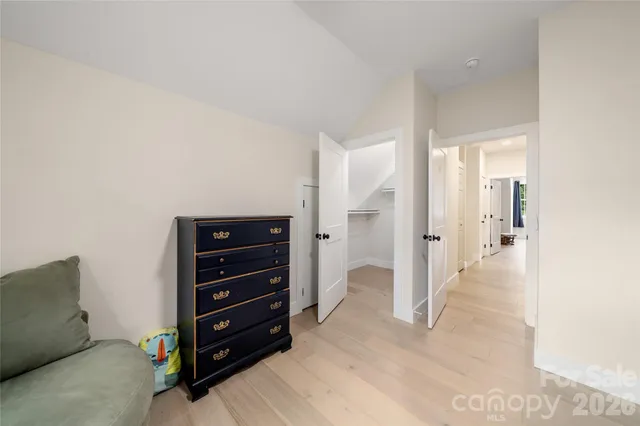 a view of room with furniture and wooden floor