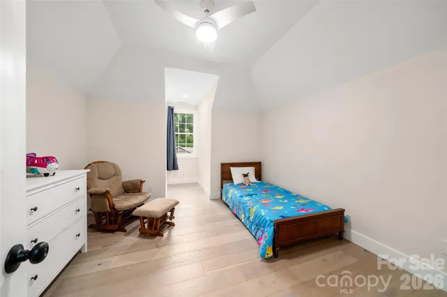 a bedroom with furniture and a window