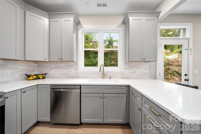 a kitchen with a sink and large window
