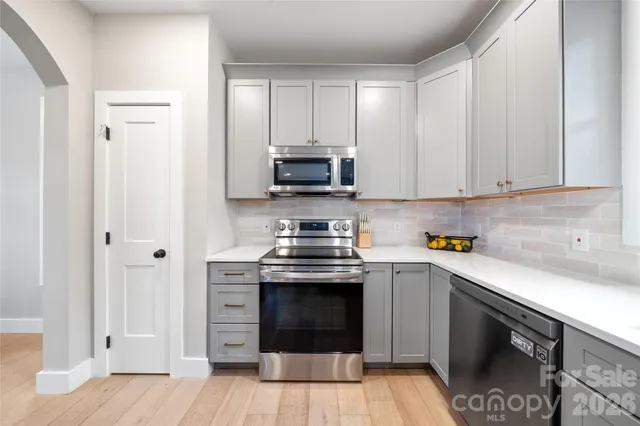 a kitchen with stainless steel appliances granite countertop a stove and a sink