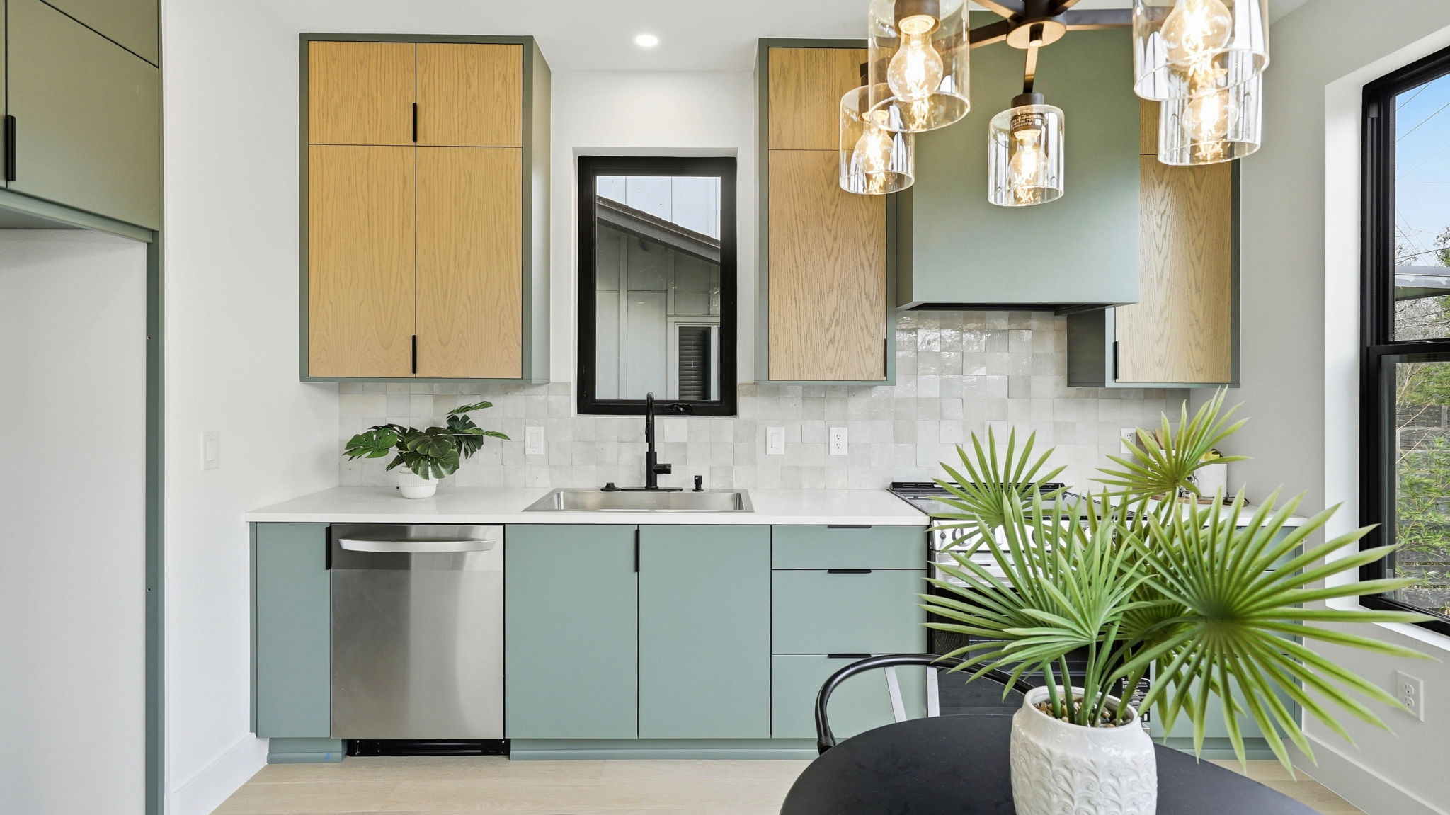 300 Lightsey Road, Unit 2 Austin, TX 78704 - Photo 13 of 28 Kitchen featuring stainless steel dishwasher, range, tasteful backsplash, pendant lighting, and light wood-type flooring