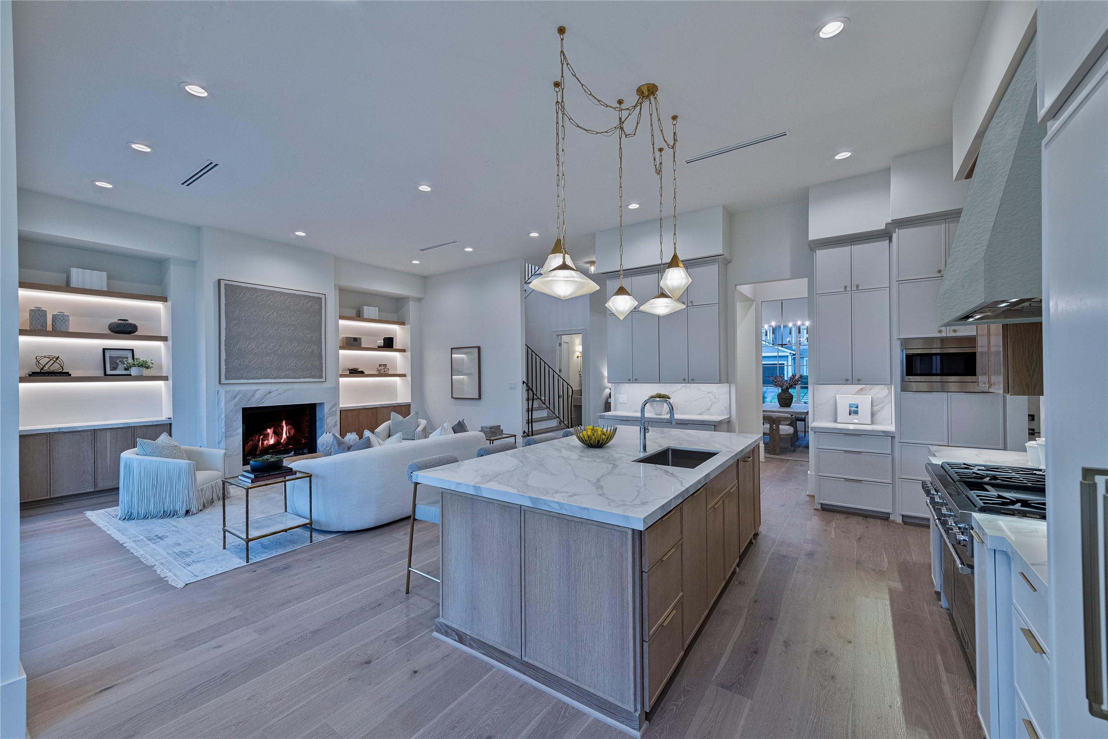 1407 Martin Street Houston, TX 77018 - Photo 3 of 33 An open modern layout features a lovely kitchen, breakfast and family room design. Notable highlights include white oak accents, modern lighting and cast stone fireplace surround.