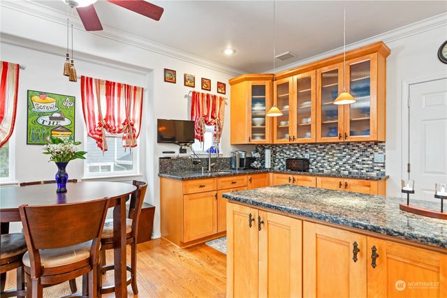 a kitchen with a table chairs sink and cabinets