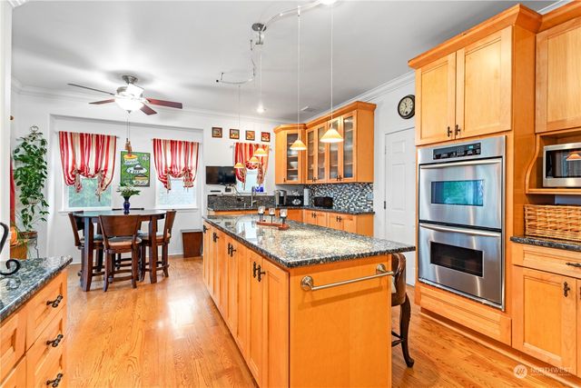 a kitchen with stainless steel appliances granite countertop a stove and a refrigerator