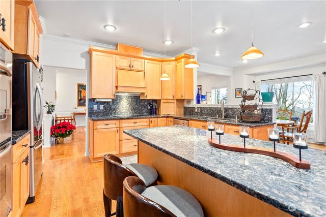 a kitchen with stainless steel appliances granite countertop sink stove and cabinets