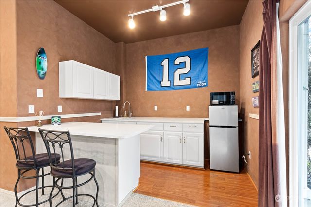 a kitchen with a refrigerator and table
