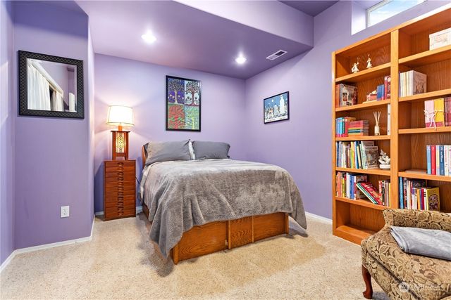 a bedroom with a bed and a book shelf