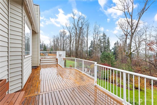 a balcony with wooden floor and trees