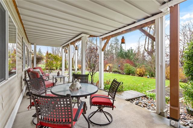 a outdoor dining space with furniture and garden view