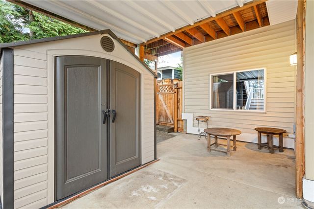 a view of a house with backyard and sitting area
