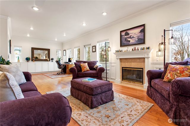 a living room with furniture fireplace and a large window