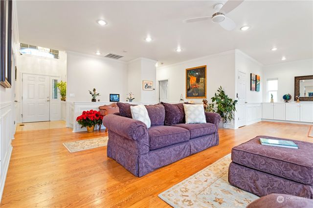 a living room with furniture and a chandelier