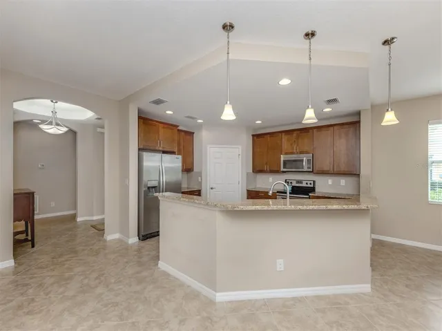 a view of a patio with a table chairs and garden