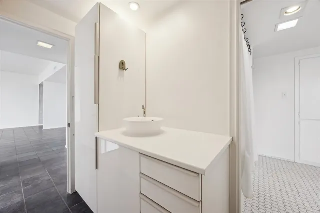 a view of a bathroom with a shower and a sink