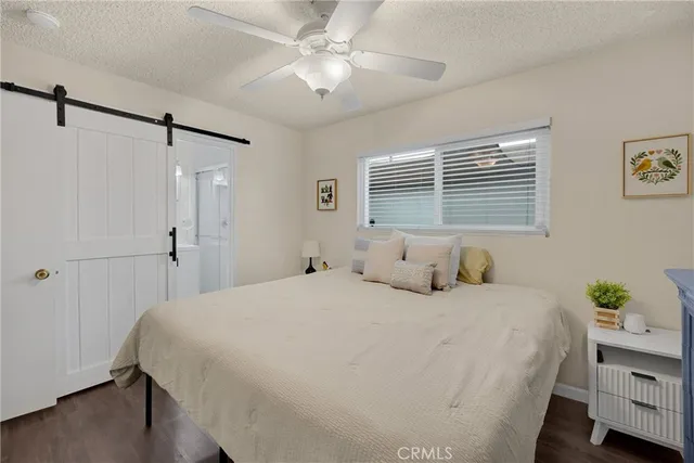 a bedroom with a bed dresser and a window