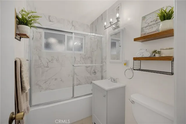 a bathroom with a shower sink and mirror