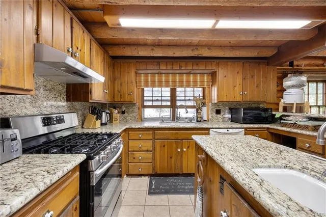 a kitchen with a stove a sink and a refrigerator