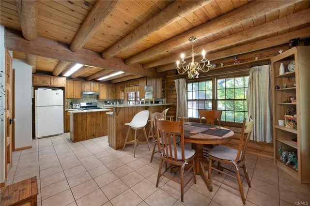 a dining room with furniture and a chandelier