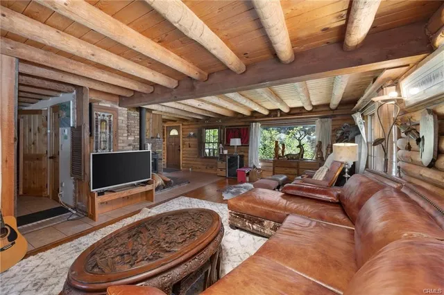 a living room with furniture a rug and a flat screen tv