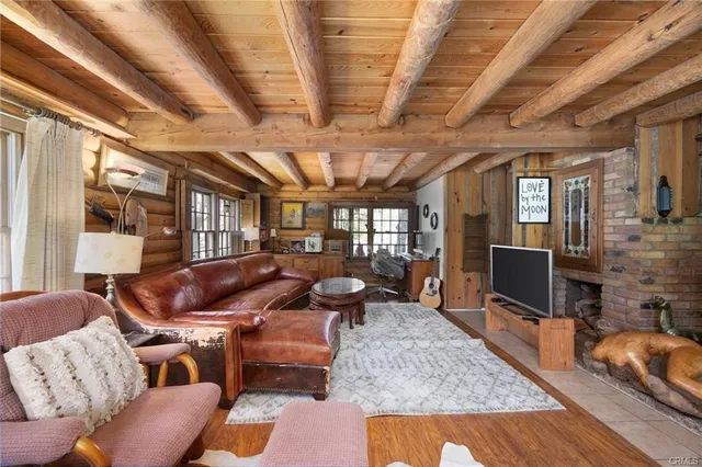 a living room with furniture a couch and a chandelier