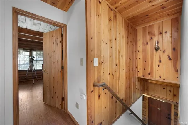 a view of a hallway with wooden floor and staircase