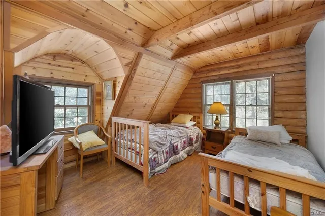 a bedroom with a bed next to a window with outer view