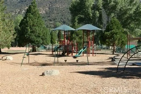a view of a swimming pool with a bench in patio