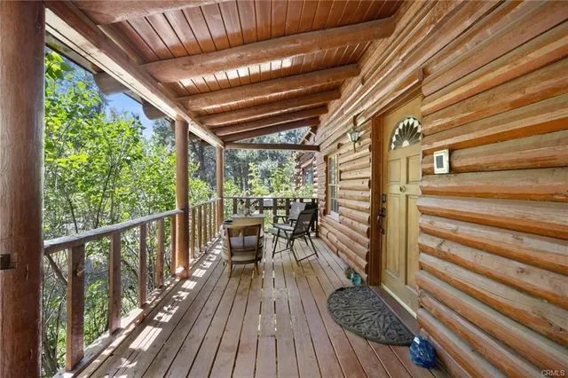 a view of balcony with chairs and wooden floor