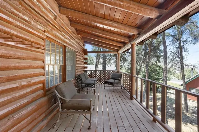 a view of balcony with furniture and wooden floor