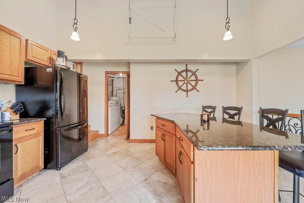 6939 Lakeview Road Hanoverton, OH 44423 - Photo 6 of 42 Kitchen with a center island, pendant lighting, light ceramic floors, and a kitchen bar