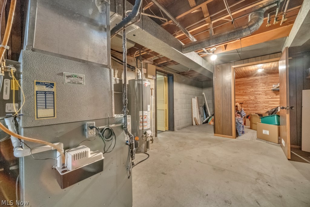 6846 Revere Road Cleveland, OH 44130 - Photo 28 of 30 Unfinished basement featuring heating unit and gas water heater